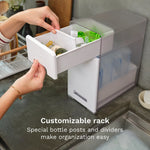 Person using a customizable bottle rack with bottle posts and dividers on a kitchen counter. - product thumbnail
