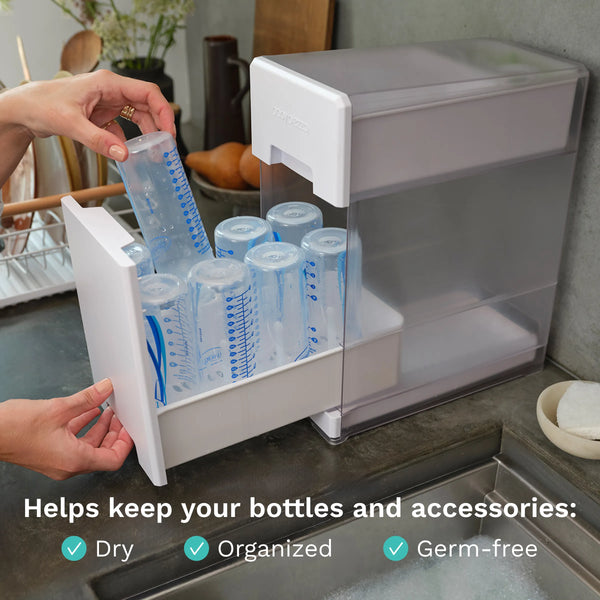 Baby Brezza Bottle drying rack with bottles on a kitchen counter, text indicating "Helps keep your bottles and accessories dry, organized, germ-free" - product thumbnail