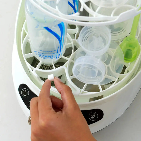 Baby Brezza Detergent tablet being put into the Bottle washer pro - product thumbnail