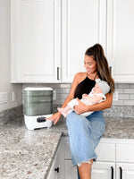 Baby Brezza Sterilizer Dryer in use by a mother with a baby in the kitchen - product thumbnail