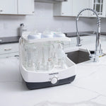 Baby Brezza Superfast sterilizer dryer open with bottles and parts in kitchen - product thumbnail