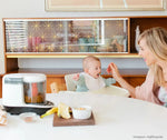 A mother feeding her child by using the Baby Brezza One step food maker - product thumbnail