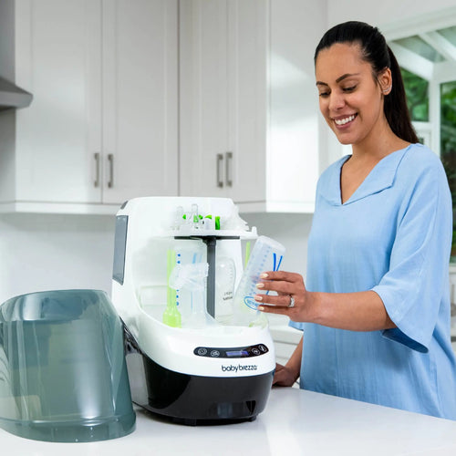 Mother using the Baby Brezza Bottle Washer Pro to clean baby bottles effortlessly - product thumbnail